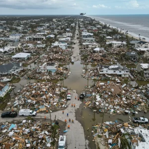 Aerial view of hurricane damage, showing emergency response and flooded areas.