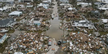 Aerial view of hurricane damage, showing emergency response and flooded areas.