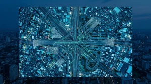 Unmasking the Pitfalls: Common Blunders in Current Events, Life Hacks, and Economic Insights Aerial drone shot of a fractured urban transport network at dusk, with highways and railways forming chaotic patterns, symbolizing fragmented and distorted news information flow. The city glows with cool blue and green lights.